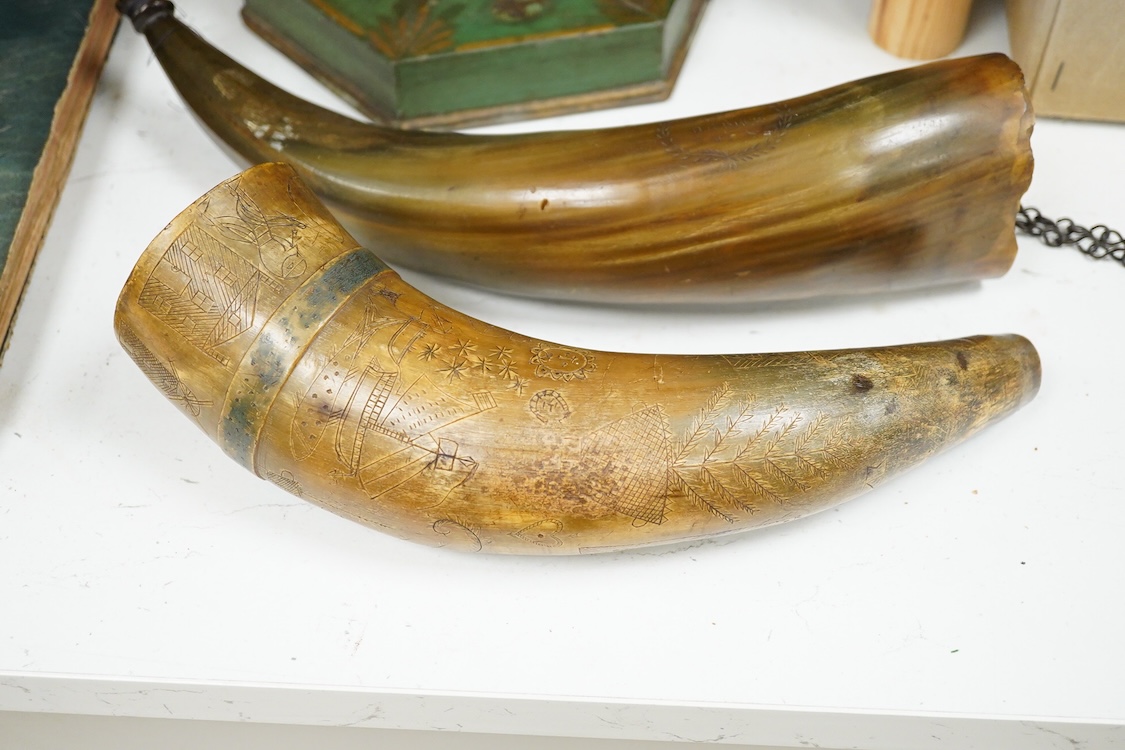 Two scrimshaw engraved cowhorn flasks the first engraved with ships, plants, fish, an anchor, a watering can and various other implements, the second engraved with a Scottish sentimental verse and the owner’s name; D. Fi